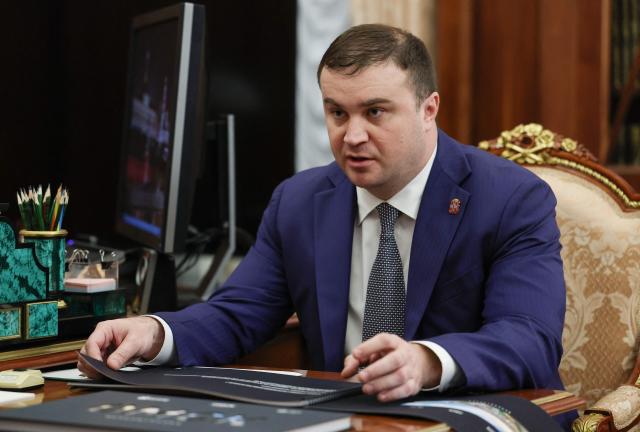 In this pool photograph distributed by the Russian state agency Sputnik, Omsk Region Governor Vitaly Khotsenko meets Russia's President in Moscow on August 11, 2025. (Photo by Vyacheslav PROKOFYEV / POOL / AFP)