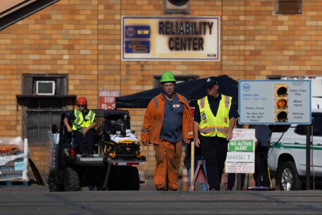 A steelworker and emergency personnel are seen at US Steel's Clairton Coke Works following an explosion at the plant in Clairton, Pennsylvania, on August 11, 2025. At least one person died and dozens were wounded on August 11 after blasts at the US Steel plant in the state of Pennsylvania, officials said. "Multiple explosions occurred today at U.S. Steel Clairton Coke Works," the state's Governor Josh Shapiro said in a post on X, naming a plant some 15 miles (25 kilometers) outside the city of Pittsburgh. (Photo by Rebecca DROKE / AFP)