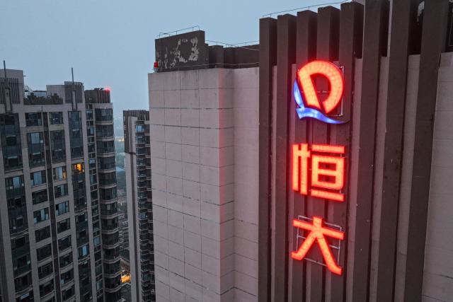 This picture shows the logo of China Evergrande Group on an apartement buildings in Nanjing, China's eastern Jiangsu province on August 13, 2025. Embattled property giant China Evergrande Group said on August 12 it will delist from Hong Kong Stock Exchange as a heavier-than-expected debt burden weighed on its liquidation process. (Photo by AFP) / China OUT