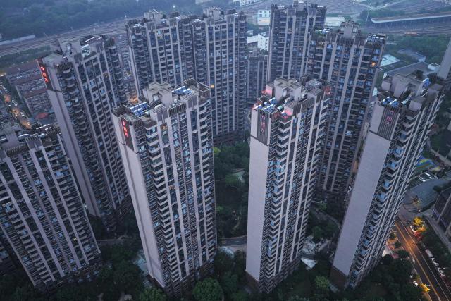 This picture shows an aerial view of apartement buildings of the China Evergrande Group in Nanjing, China's eastern Jiangsu province on August 13, 2025. Embattled property giant China Evergrande Group said on August 12 it will delist from Hong Kong Stock Exchange as a heavier-than-expected debt burden weighed on its liquidation process. (Photo by AFP) / China OUT
