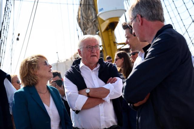 German President Frank-Walter Steinmeier and his wife Elke Buedenbender (L) stand onboard the German Navy training sailing ship 'Gorch Fock' during the maritime event "Sail Bremerhaven" in Bremerhaven, Germany, on August 13, 2025. (Photo by Leon Kuegeler / POOL / AFP)