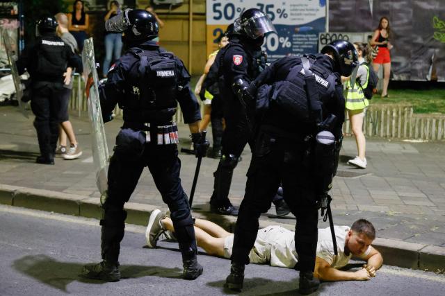 Serbian riot police clashes with an anti-government protester in Belgrade on August 13, 2025. Rallies are taking place simultaneously across the Balkan country, with people gathering in several locations in the capital, Belgrade, as well as in many cities and towns, with heightened tensions in several locations.
The rallies come after a night of violent clashes in towns and cities on Tuesday, when large groups of masked men, some wielding batons, confronted anti-graft demonstrators outside the ruling party offices.
For nearly nine months, large rallies -- some drawing hundreds of thousands to the streets -- have demanded a transparent investigation into the tragedy and are now calling for snap elections. (Photo by Marko Djokovic / AFP)