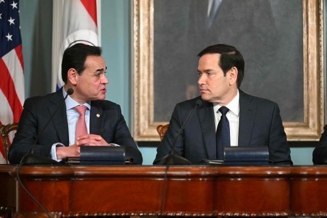 US Secretary of State Marco Rubio (C) speaks with Foreign Minister of Paraguay Ruben Ramirez Lezcano (L) ahead of signing a memorandum of understanding in the Treaty Room of the State Department in Washington, DC, on August 14, 2025. (Photo by Jim WATSON / AFP)