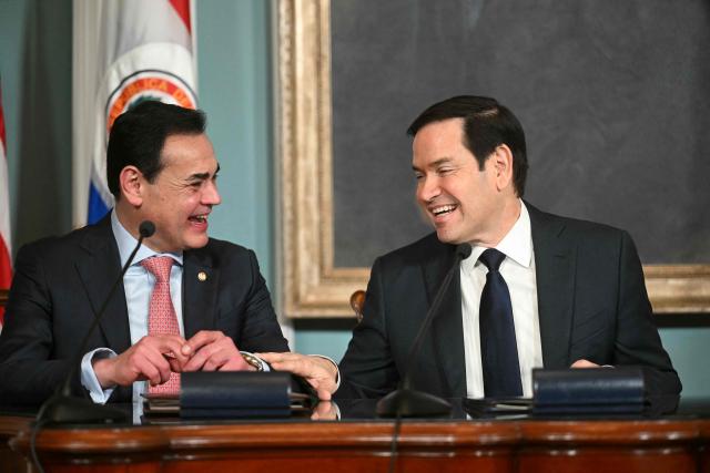 US Secretary of State Marco Rubio (C) speaks with Foreign Minister of Paraguay Ruben Ramirez Lezcano (L) ahead of signing a memorandum of understanding in the Treaty Room of the State Department in Washington, DC, on August 14, 2025. (Photo by Jim WATSON / AFP)
