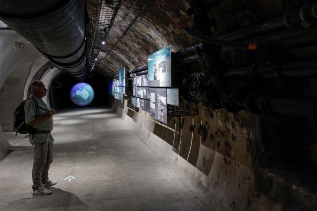 A visitor looks at the displays at the Musee des Egouts de Paris, the Sewers Museum, in Paris on August 14, 2025. (Photo by STEPHANE DE SAKUTIN / AFP)