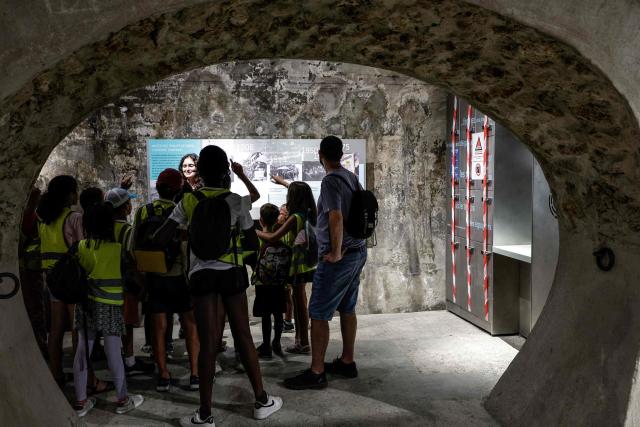 A group of children visit the Musee des Egouts de Paris, the Sewers Museum, in Paris on August 14, 2025. (Photo by STEPHANE DE SAKUTIN / AFP)