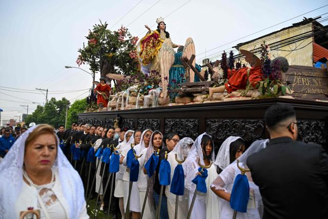 Catholic faithful carry the image of the Virgin of the Assumption as they take part in a parade to celebrate the day of the city's patron saint in Guatemala City on August 15, 2025. (Photo by JOHAN ORDONEZ / AFP)