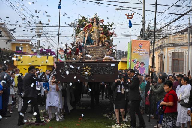 Catholic faithful carry the image of the Virgin of the Assumption as they take part in a parade to celebrate the day of the city's patron saint in Guatemala City on August 15, 2025. (Photo by JOHAN ORDONEZ / AFP)