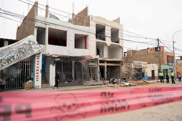 The damaged facade of a house that suffered a dynamite attack caused by clashes between criminal organizations is pictured in the city of Trujillo, northern Peru on August 15, 2025. At least three people were injured and a hundred homes were affected by a dynamite attack in the Peruvian city of Trujillo, which took place during clashes between criminal organisations, authorities reported on Friday. (Photo by AFP)