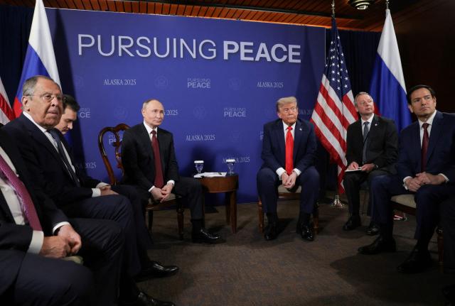 In this pool photograph distributed by the Russian state agency Sputnik, US President Donald Trump (C, R) and Russian President Vladimir Putin (C, L) meet, along with Russian Foreign Minister Sergei Lavrov (R) and US Secretary of State Marco Rubio (R), during a US-Russia summit on Ukraine at Joint Base Elmendorf-Richardson in Anchorage, Alaska, on August 15, 2025. (Photo by Gavriil GRIGOROV / POOL / AFP)