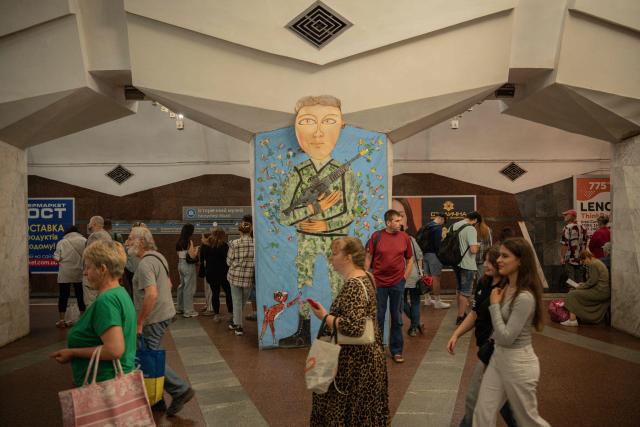 People walk inside a subway station in Kharkiv, on August 18, 2025, amid the Russian invasion of Ukraine. (Photo by Ivan SAMOILOV / AFP)