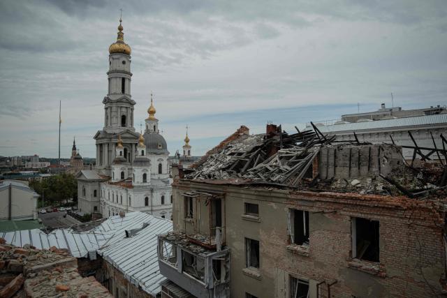 This photograph shows a general view of a damaged building and a church behing it in Kharkiv, on August 18, 2025, amid the Russian invasion of Ukraine. (Photo by Ivan SAMOILOV / AFP)
