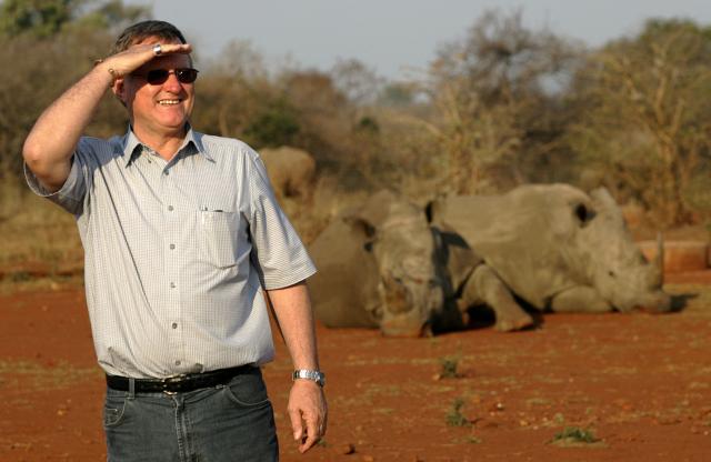 (FILES) Zimbabwe-born, multi-millionaire game farmer John Hume poses September 30, 2004 on his land outside the northeastern town of Malelane, next to Kruger National Park. The former owner of a huge South African rhino conservation farm was arrested Tuesday on charges of smuggling the horns of the endangered animals, police said. 
John Hume was arrested alongside five others following a seven-year "complex investigation into transnational trafficking of rhino horns", the police's specialised Hawks unit said. (Photo by ALEXANDER JOE / AFP)