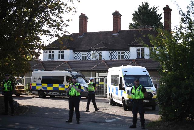 (FILES) Police officers stand outside the The Bell Hotel, believed to be housing asylum seekers, in Epping, northeast of London, on August 8, 2025, as protests are expected from far right groups. A UK judge on Tuesday, August 19, blocked asylum seekers from being housed at a hotel in a town which has witnessed violent protests, dealing a blow to the government. (Photo by HENRY NICHOLLS / AFP)