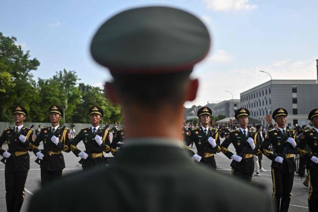 Chinese military personnel take part in a rehearsal ahead of the parade commemorating the 80th anniversary of the victory in the Chinese People's War of Resistance Against Japanese Aggression and the World Anti-Fascist War, which will be held on September 3, in Beijing on August 20, 2025. (Photo by Pedro PARDO / AFP)