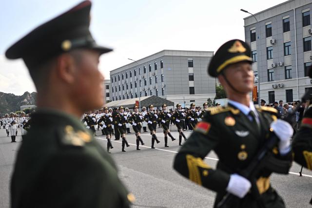 Chinese military personnel take part in a rehearsal ahead of the parade commemorating the 80th anniversary of the victory in the Chinese People's War of Resistance Against Japanese Aggression and the World Anti-Fascist War, which will be held on September 3, in Beijing on August 20, 2025. (Photo by Pedro PARDO / AFP)