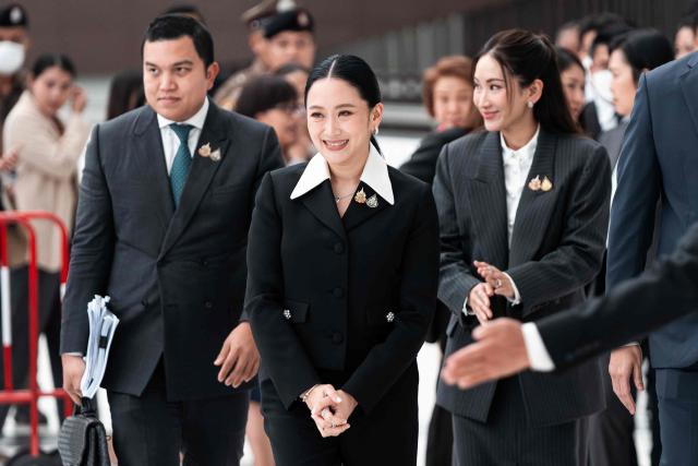 Thailand's suspended Prime Minister Paetongtarn Shinawatra (C) and her sister Pintongta Shinawatra (L) walk out of the Constitutional Court in Bangkok on August 21, 2025. Thailand's suspended prime minister Paetongtarn Shinawatra testified on August 21 in a case seeking her removal from office over her handling of the kingdom's border row with Cambodia. (Photo by Chanakarn Laosarakham / AFP)