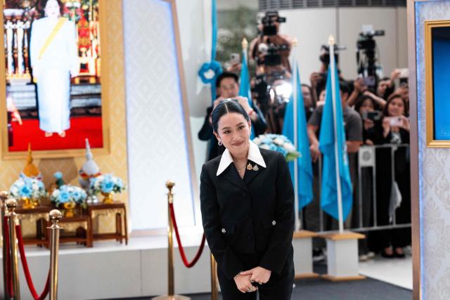 Thailand's suspended Prime Minister Paetongtarn Shinawatra smiles as she leaves the Constitutional Court in Bangkok on August 21, 2025. Thailand's suspended prime minister Paetongtarn Shinawatra testified on August 21 in a case seeking her removal from office over her handling of the kingdom's border row with Cambodia. (Photo by Chanakarn Laosarakham / AFP)