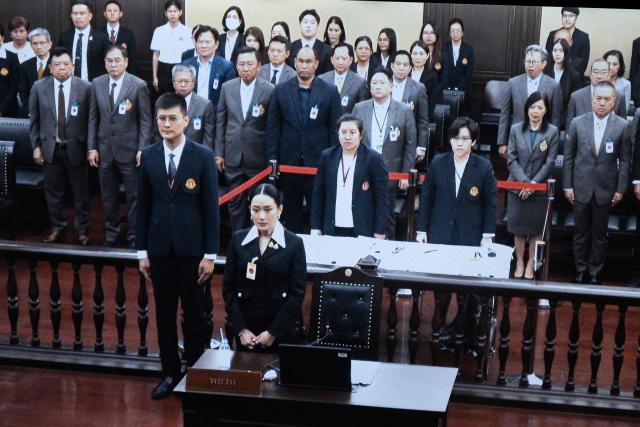 A monitor shows Thailand's suspended Prime Minister Paetongtarn Shinawatra (bottom C) during proceedings at the Constitutional Court in Bangkok on August 21, 2025. Thailand's suspended prime minister Paetongtarn Shinawatra testified on August 21 in a case seeking her removal from office over her handling of the kingdom's border row with Cambodia. (Photo by Chanakarn Laosarakham / AFP)