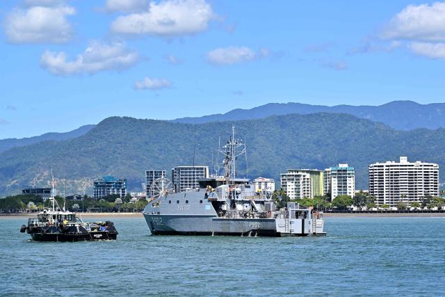 This photo taken on August 18, 2025 shows a police boat patrolling near the shoreline of Cairns, Queensland. (Photo by Saeed KHAN / AFP)
