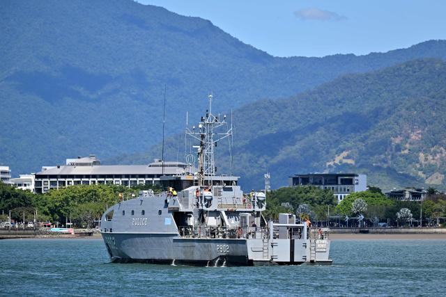 This photo taken on August 18, 2025 shows a police boat patrolling near the shoreline of Cairns, Queensland. (Photo by Saeed KHAN / AFP)