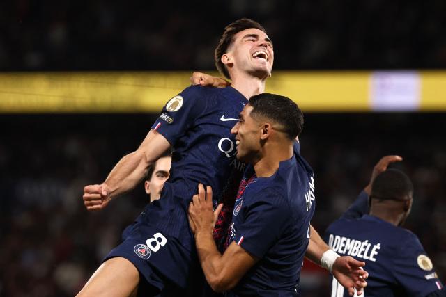 Paris Saint-Germain's Spanish midfielder #08 Fabian Ruiz celebrates with Paris Saint-Germain's Moroccan defender #02 Achraf Hakimi (R) after scoring his team's first goal during the French L1 football match between Paris Saint-Germain (PSG) and Angers SCO at the Parc des Princes Stadium in Paris on August 22, 2025. (Photo by FRANCK FIFE / AFP)