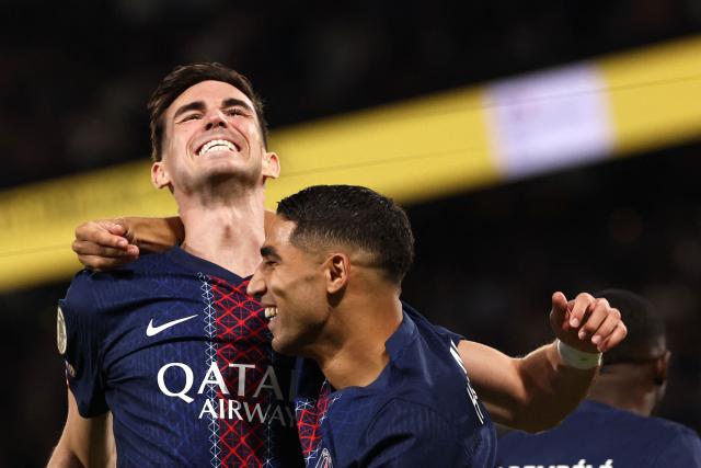 Paris Saint-Germain's Spanish midfielder #08 Fabian Ruiz celebrates with Paris Saint-Germain's Moroccan defender #02 Achraf Hakimi (R) after scoring his team's first goal during the French L1 football match between Paris Saint-Germain (PSG) and Angers SCO at the Parc des Princes Stadium in Paris on August 22, 2025. (Photo by FRANCK FIFE / AFP)