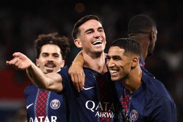 Paris Saint-Germain's Spanish midfielder #08 Fabian Ruiz celebrates with Paris Saint-Germain's Moroccan defender #02 Achraf Hakimi (R) after scoring his team's first goal during the French L1 football match between Paris Saint-Germain (PSG) and Angers SCO at the Parc des Princes Stadium in Paris on August 22, 2025. (Photo by FRANCK FIFE / AFP)