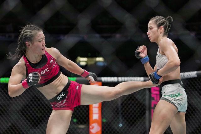 China's Shi Ming (L) fights against Brazil's Bruna Brasil during their women's Strawweight event of the UFC Fight Night in Shanghai on August 22, 2025. (Photo by -STR / AFP) / China OUT