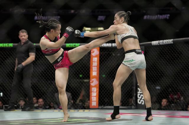 China's Shi Ming (L) fights against Brazil's Bruna Brasil during their women's Strawweight event of the UFC Fight Night in Shanghai on August 22, 2025. (Photo by -STR / AFP) / China OUT