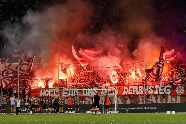 St Pauli Fans cheer for their team at the end of the German first division Bundesliga football match between FC St Pauli and Borussia Dortmund in Hamburg, northern Germany on August 23, 2025. (Photo by IBRAHIM OT / AFP) / DFL REGULATIONS PROHIBIT ANY USE OF PHOTOGRAPHS AS IMAGE SEQUENCES AND/OR QUASI-VIDEO