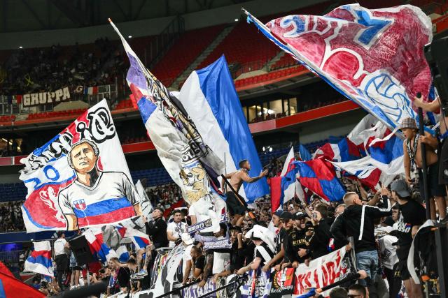 Lyon’s supporters cheer from the stands during the French L1 football match between Olympique Lyonnais (OL) and FC Metz at the Groupama Stadium in Decines-Charpieu, central-eastern France on August 23, 2025. (Photo by ARNAUD FINISTRE / AFP)