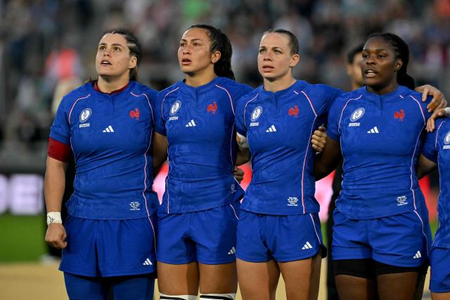 France's prop Annaelle Deshayes (L) sings the national anthem before the Women’s Rugby World Cup pool D match between France and Italy at Sandy Park in Exeter, southwest England, on August 23, 2025. (Photo by Glyn KIRK / AFP)