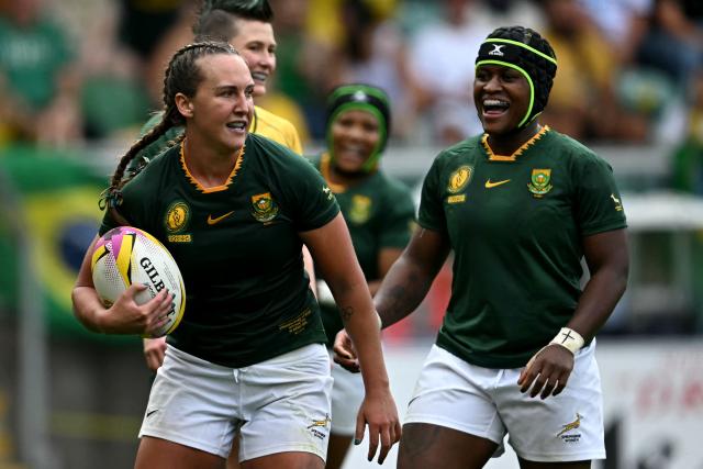 South Africa's fly half Libbie Janse van Rensburg (L) celebrates scoring a try during the Women’s Rugby World Cup pool D match between South Africa and Brazil at Franklin's Gardens in Northampton, central England, on August 24, 2025. (Photo by Paul ELLIS / AFP)