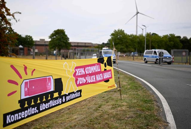 Demonstrators protest against the Castor transports in front of the Ahaus interim storage facility in Ahaus, western Germany on August 26, 2025. On August 26, 2025, the Federal Office for the Safety of Nuclear Waste Disposal (BASE) approved the controversial transport of nuclear waste from Juelich in the Rhineland to the interim storage facility in Ahaus in the Münsterland region. Spontaneous protests have now been announced in Juelich and Ahaus. (Photo by Ina FASSBENDER / AFP)