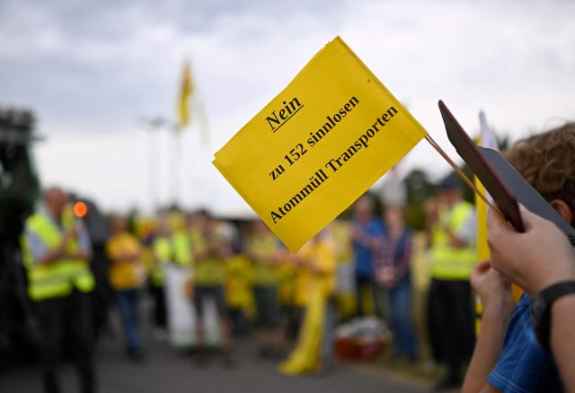 Demonstrators protest against the Castor transports in front of the Ahaus interim storage facility in Ahaus, western Germany on August 26, 2025. On August 26, 2025, the Federal Office for the Safety of Nuclear Waste Disposal (BASE) approved the controversial transport of nuclear waste from Juelich in the Rhineland to the interim storage facility in Ahaus in the Münsterland region. Spontaneous protests have now been announced in Juelich and Ahaus. (Photo by Ina FASSBENDER / AFP)