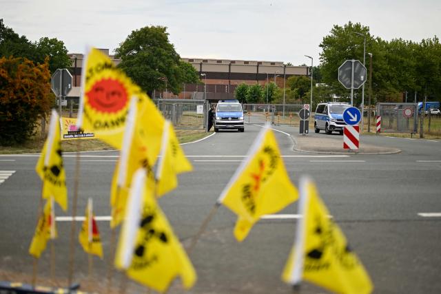 Demonstrators protest against the Castor transports in front of the Ahaus interim storage facility in Ahaus, western Germany on August 26, 2025. On August 26, 2025, the Federal Office for the Safety of Nuclear Waste Disposal (BASE) approved the controversial transport of nuclear waste from Juelich in the Rhineland to the interim storage facility in Ahaus in the Münsterland region. Spontaneous protests have now been announced in Juelich and Ahaus. (Photo by Ina FASSBENDER / AFP)