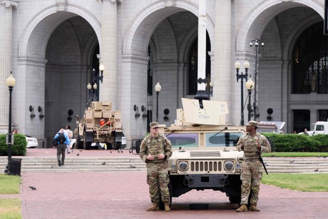 (FILES) Members of the National Guard stand watch outside of Union Station in Washington, DC, under orders from the Trump administration on August 19, 2025. According to US media reports on August 27, the US Department of Transportation is planning to take over management of Union Station in Washington, DC. (Photo by SAUL LOEB / AFP)