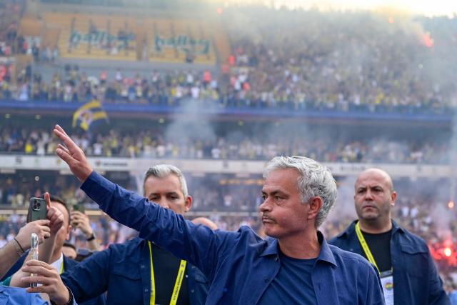 (FILES) New coach of Turkish club Fenerbahce Jose Mourinho (C) waves during the presentation to the supporters at the Sukru Saracoglu Stadium in Istanbul on June 2, 2024. Turkish club Fenerbahçe, eliminated on August 28, 2025 in the Champions League play-offs against Benfica, announced on August 29, 2025 that it was parting ways with its Portuguese coach José Mourinho. (Photo by Yasin AKGUL / AFP)