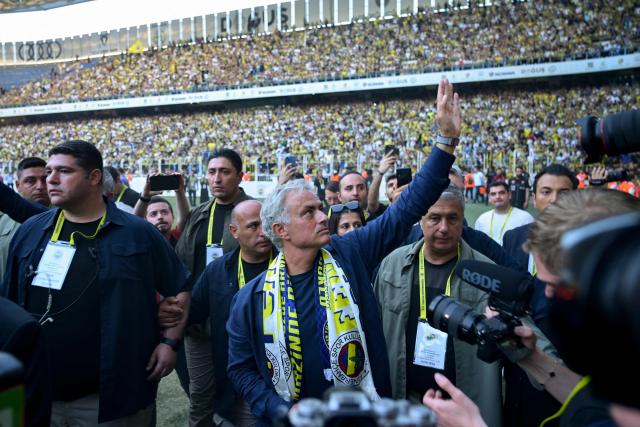 (FILES) New coach of Turkish club Fenerbahce Jose Mourinho (C) waves during the presentation to the supporters at the Sukru Saracoglu Stadium in Istanbul on June 2, 2024. Turkish club Fenerbahçe, eliminated on August 28, 2025 in the Champions League play-offs against Benfica, announced on August 29, 2025 that it was parting ways with its Portuguese coach José Mourinho. (Photo by Yasin AKGUL / AFP)