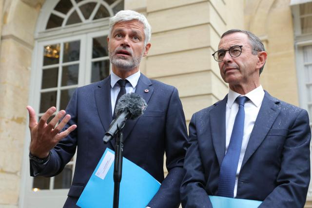 President of French right-wing Les Republicains (LR) party, France's Minister of the Interior Bruno Retailleau (R) and President of the Droite Republicaine group at the National Assembly Laurent Wauquiez (L) deliver a statement to journalists after attending a meeting with France's Prime Minister as part of political consultations at the Hotel de Matignon in Paris, on September 2, 2025, a week before the French National Assembly's vote of confidence. (Photo by Thomas SAMSON / AFP)