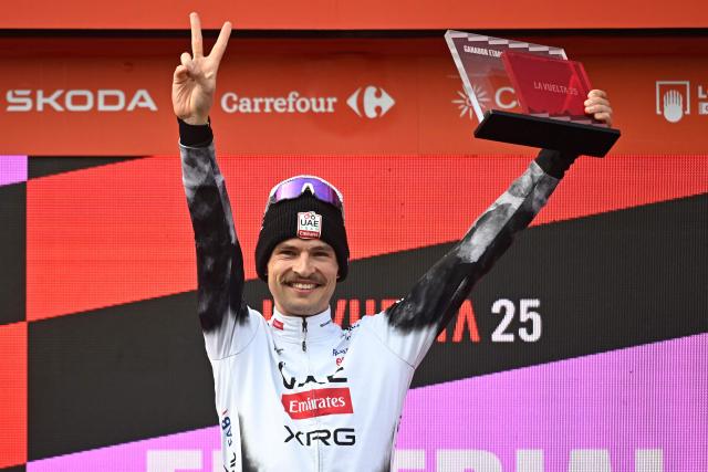 Team UAE's Australian rider Jay Vine celebrates on the podium after winning the tenth stage of the Vuelta a Espana cycling tour, a 168 km race between Sendaviva Natural Park in Arguedas and El Ferial Larra Belagua in Isaba, on September 2, 2025. (Photo by ANDER GILLENEA / AFP)