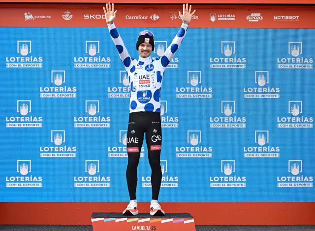 Stage winner Team UAE's Australian rider Jay Vine celebrates on the podium wearing the best climber dotted jersey after the tenth stage of the Vuelta a Espana cycling tour, a 168 km race between Sendaviva Natural Park in Arguedas and El Ferial Larra Belagua in Isaba, on September 2, 2025. (Photo by Ander GILLENEA / AFP)