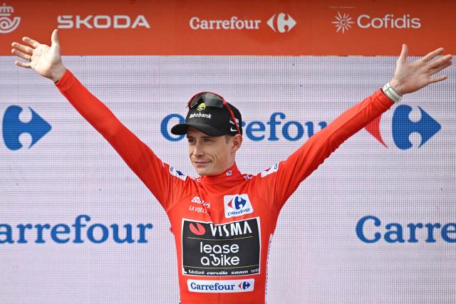 The overall leader Team Visma-Lease a bike's Danish rider Jonas Vingegaard celebrates on the podium wearing the red jersey after the tenth stage of the Vuelta a Espana cycling tour, a 168 km race between Sendaviva Natural Park in Arguedas and El Ferial Larra Belagua in Isaba, on September 2, 2025. (Photo by Ander GILLENEA / AFP)