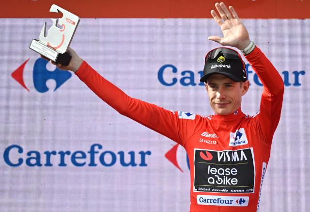The overall leader Team Visma-Lease a bike's Danish rider Jonas Vingegaard celebrates on the podium wearing the red jersey after the tenth stage of the Vuelta a Espana cycling tour, a 168 km race between Sendaviva Natural Park in Arguedas and El Ferial Larra Belagua in Isaba, on September 2, 2025. (Photo by Ander GILLENEA / AFP)