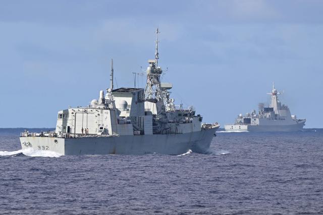 A monitoring Chinese PLA Navy ship (background R) sails while the Royal Canadian Navy frigate HMCS Ville de Quebec takes part in a maritime cooperative activity between the Philippines, Australia and Canadian navies near Scarborough Shoal in disputed waters of the South China Sea on September 3, 2025. (Photo by Ted ALJIBE / AFP)