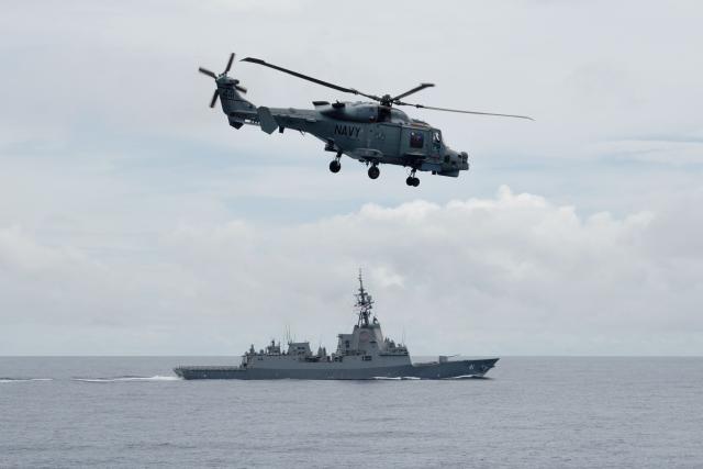 A Philippine Navy AW159 Wildcat helicopter is seen in flight while the Royal Australian Navy destroyer HMAS Brisbane sails during a maritime cooperative activity between the Philippines, Australia and Canadian navies near Scarborough Shoal in disputed waters of the South China Sea on September 2, 2025.  (Photo by Ted ALJIBE / AFP)