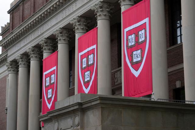 (FILES) Harvard University banners hang in front of Widener Library during the 374th Harvard Commencement in Harvard Yard in Cambridge, Massachusetts, on May 29, 2025. A US judge ordered on September 3, 2025 that deep funding cuts by the Trump administration to Harvard University be overturned, after they were imposed over claims of anti-Semitism and bias at the Ivy League institution. Harvard sued in April to restore more than $2 billion in frozen funds. The administration insisted its move was legally justified over Harvard's alleged failure to protect Jewish and Israeli students, particularly amid campus protests against Israel's war in Gaza. (Photo by Rick Friedman / AFP)