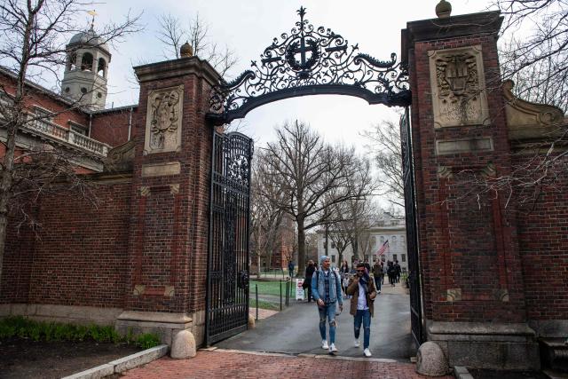 (FILES) People walk through a gate as they exit Harvard Yard on the campus of Harvard University campus in Cambridge, Massachussetts, on April 15, 2025. A US judge ordered on September 3, 2025 that deep funding cuts by the Trump administration to Harvard University be overturned, after they were imposed over claims of anti-Semitism and bias at the Ivy League institution. Harvard sued in April to restore more than $2 billion in frozen funds. The administration insisted its move was legally justified over Harvard's alleged failure to protect Jewish and Israeli students, particularly amid campus protests against Israel's war in Gaza. (Photo by Joseph Prezioso / AFP)