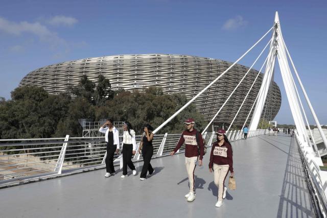 People walk near the new Prince Moulay Abdellah Stadium in Rabat, which was completely demolished in 2023 and rebuilt according to the latest international standards, in Rabat, on September 5, 2025, ahead of the FIFA World Cup 2026 Group E African qualification football match between Morocco and Niger. The stadium built in preparation for two major events: the 2025 Africa Cup of Nations and the 2030 FIFA World Cup, co-hosted by Morocco, Spain, and Portugal. (Photo by Abdel Majid BZIOUAT / AFP)